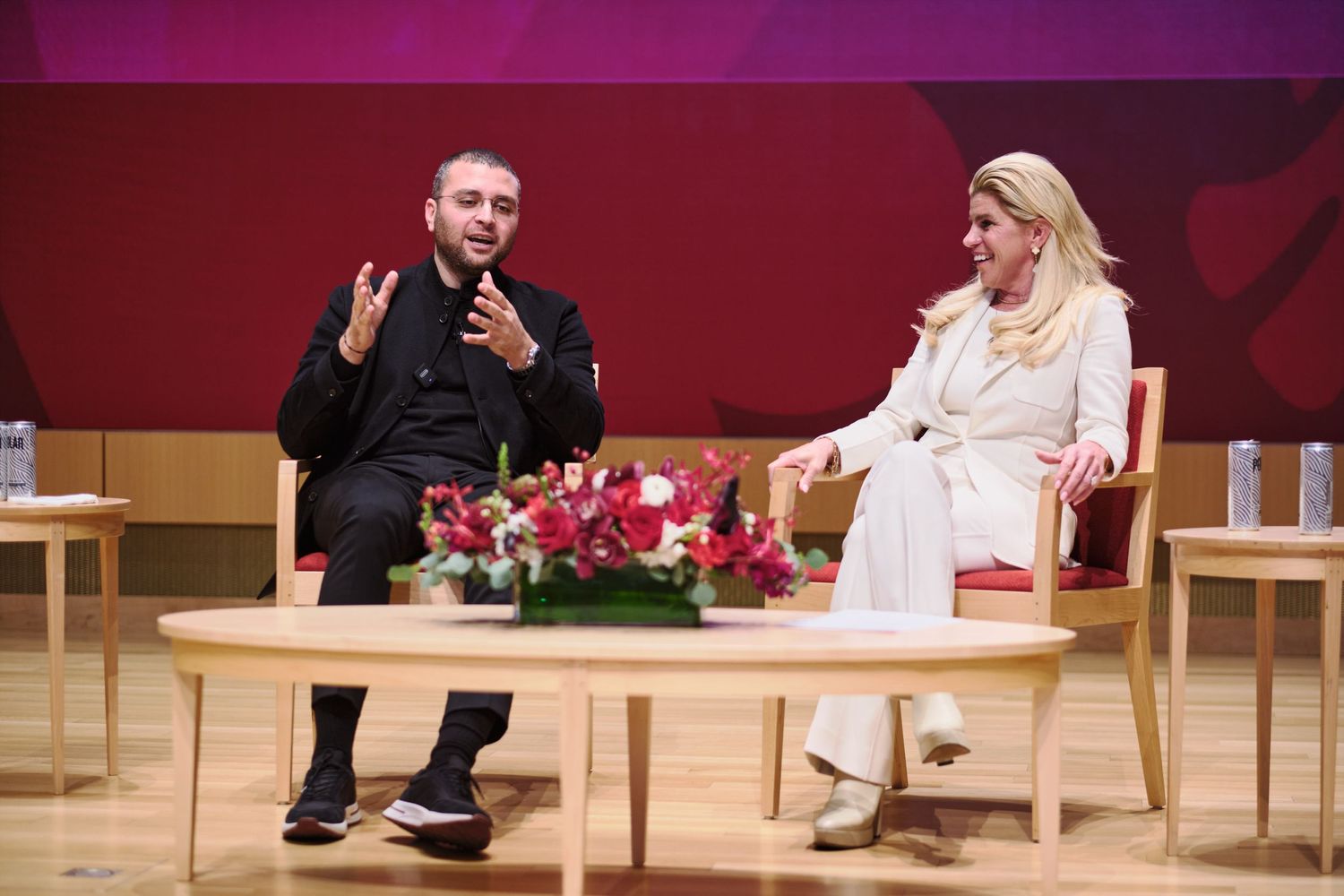 Two speakers in conversation on a conference stage