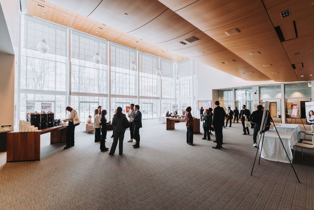 Conference delegates networking in a bright event lobby