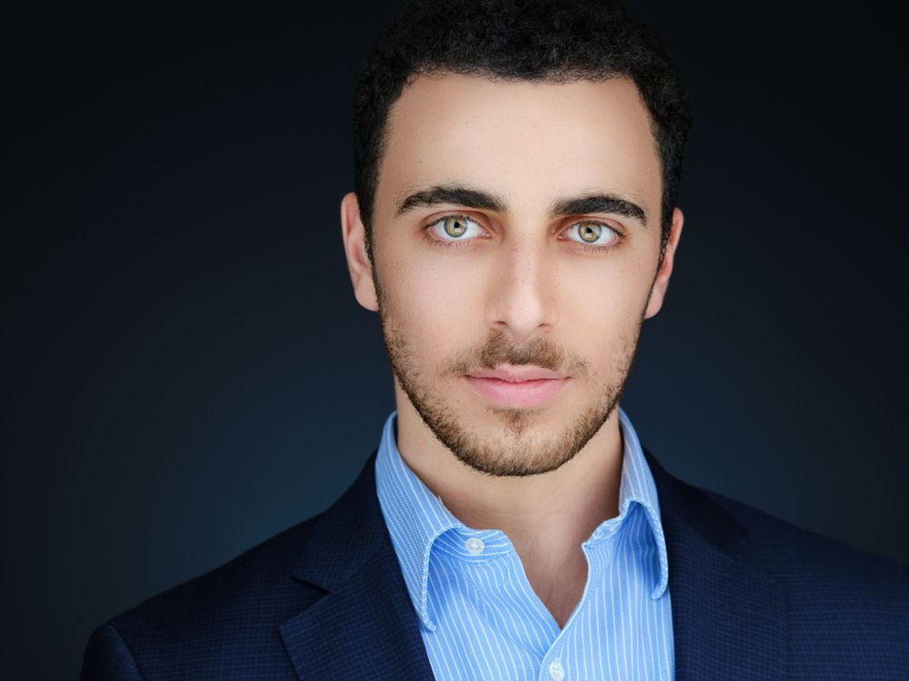 Professional conference headshot on a dark background
