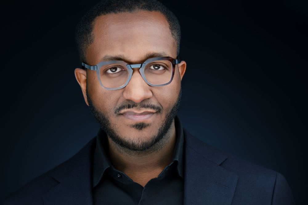 Professional headshot of a guest wearing glasses